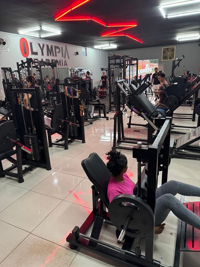Área de musculação da Olympia Academia, com aparelhos e alunos treinando